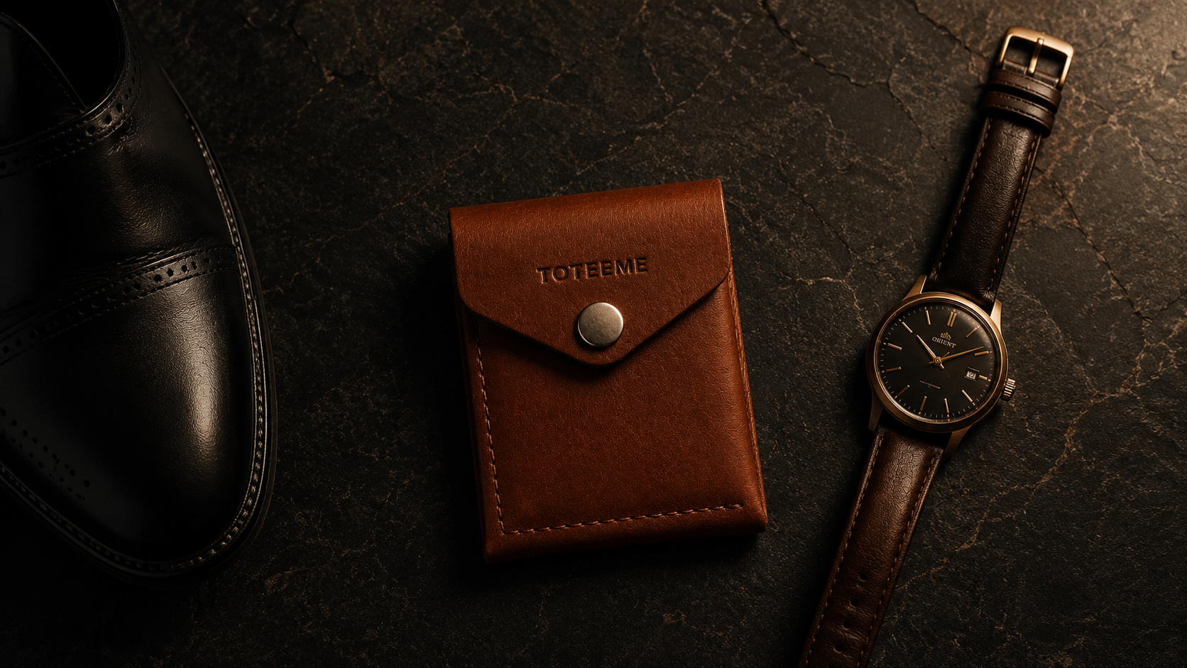 Toteeme leather goods on dark stone
